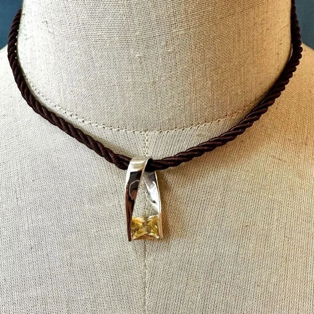 Cookie Lee yellow rhinestone pendant necklace on brown cord